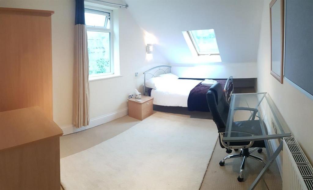A bright and well-maintained bedroom with a com...