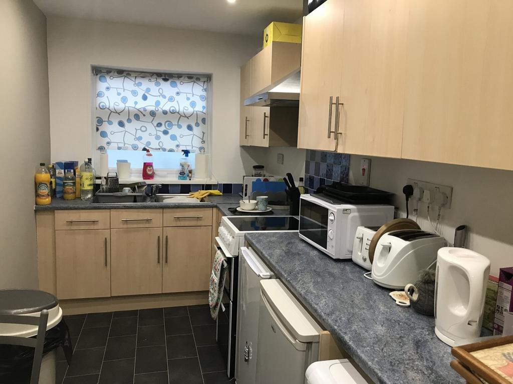 A tidy and functional kitchenette with ample st...