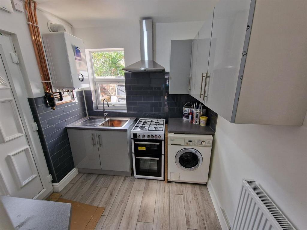 Bright and tidy kitchen featuring modern applia...