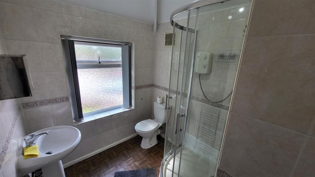 A clean and modern bathroom featuring a glass-e...