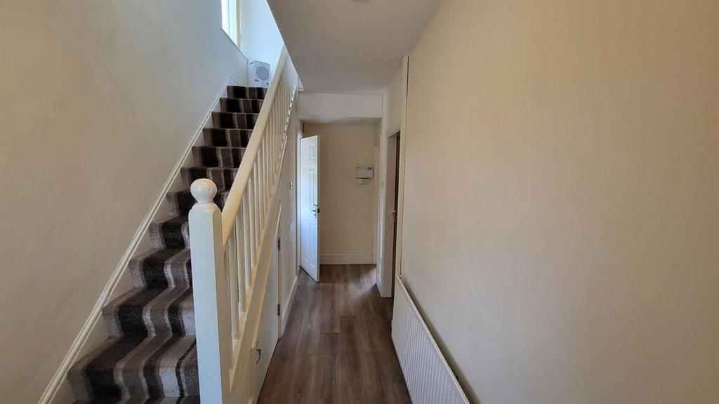 A clean and well-maintained hallway featuring a...