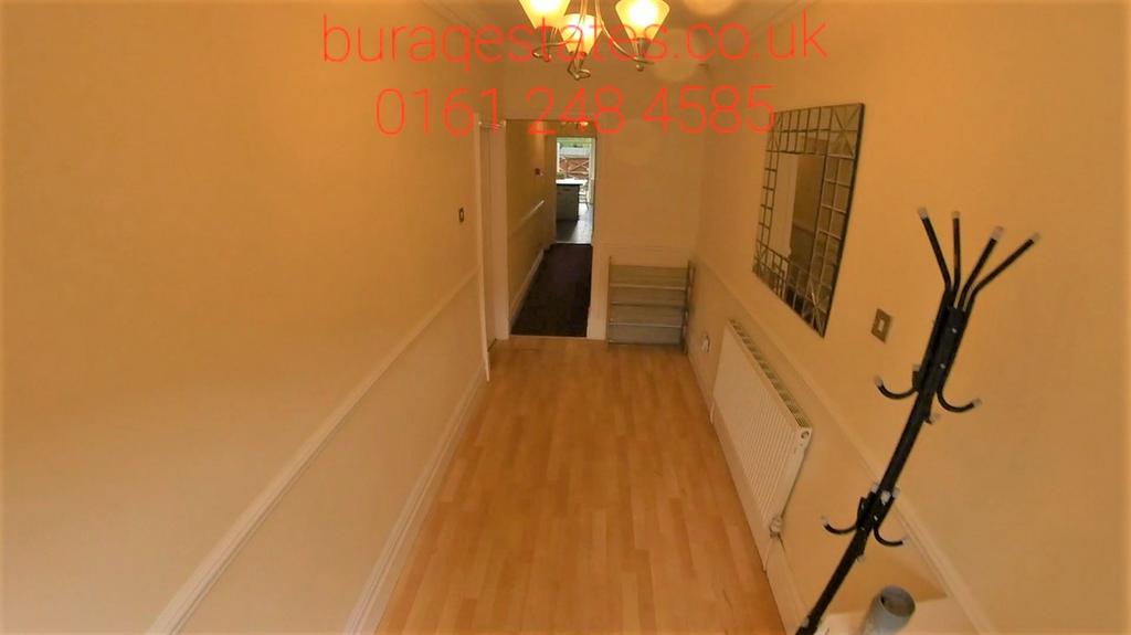 A bright hallway featuring light wood flooring,...