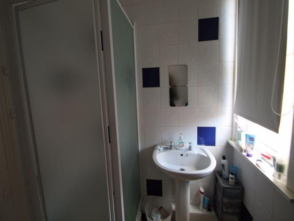 A bright bathroom featuring a pedestal sink, fr...