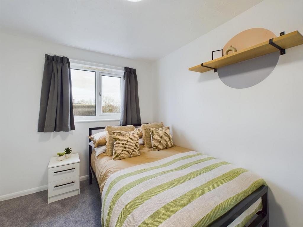 A bright and inviting double bedroom featuring ...