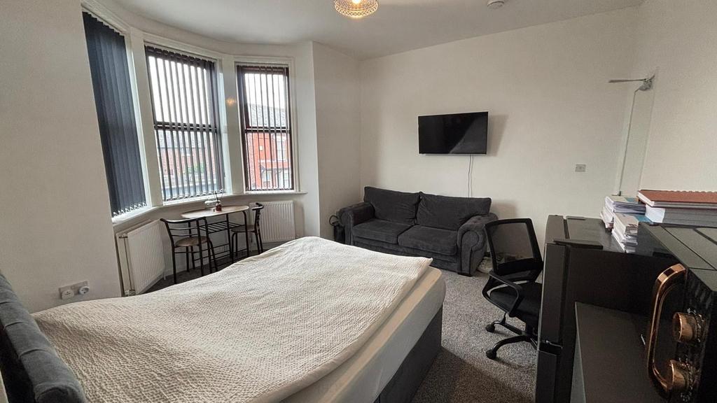 Spacious master bedroom featuring a comfortable...