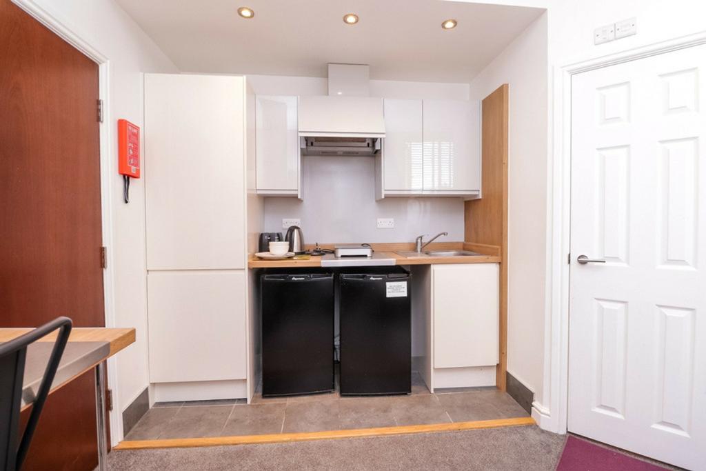 A modern and tidy kitchenette featuring ample s...