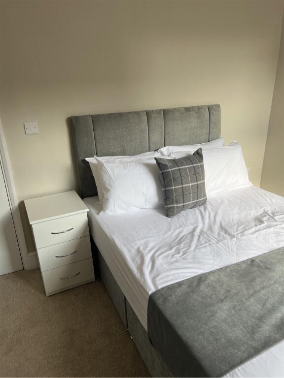 A tidy and inviting double bedroom featuring a ...