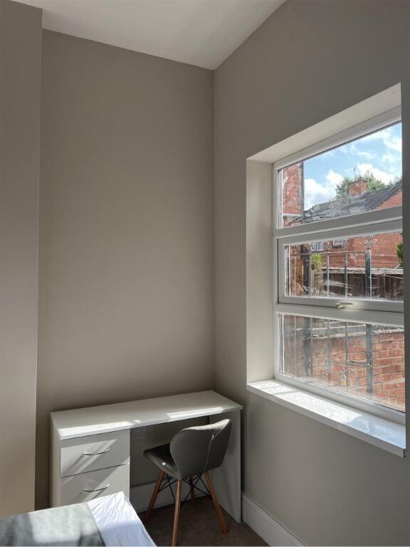 A bright, minimalist study nook with a clean wh...