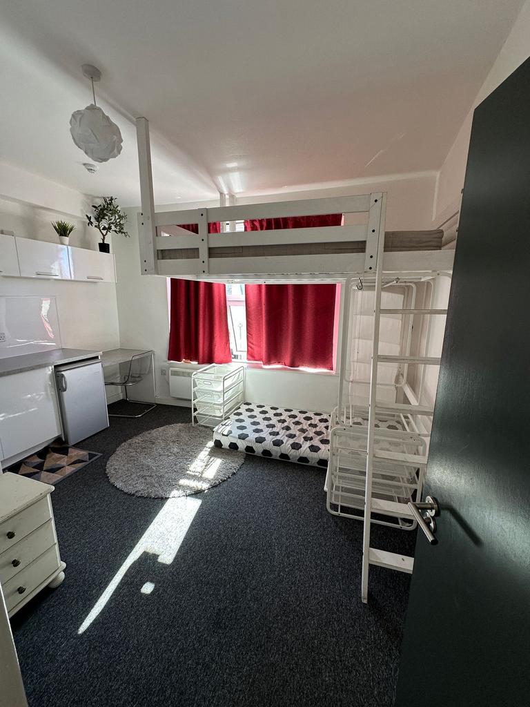 A bright and functional student bedroom featuri...
