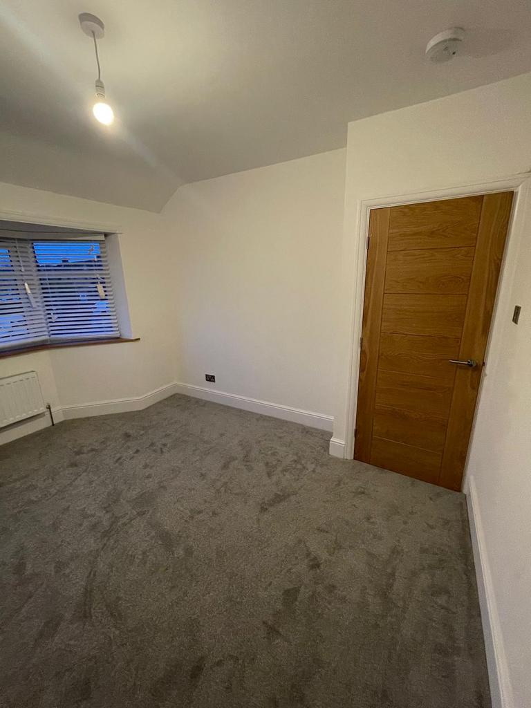 A clean and well-maintained room featuring a so...