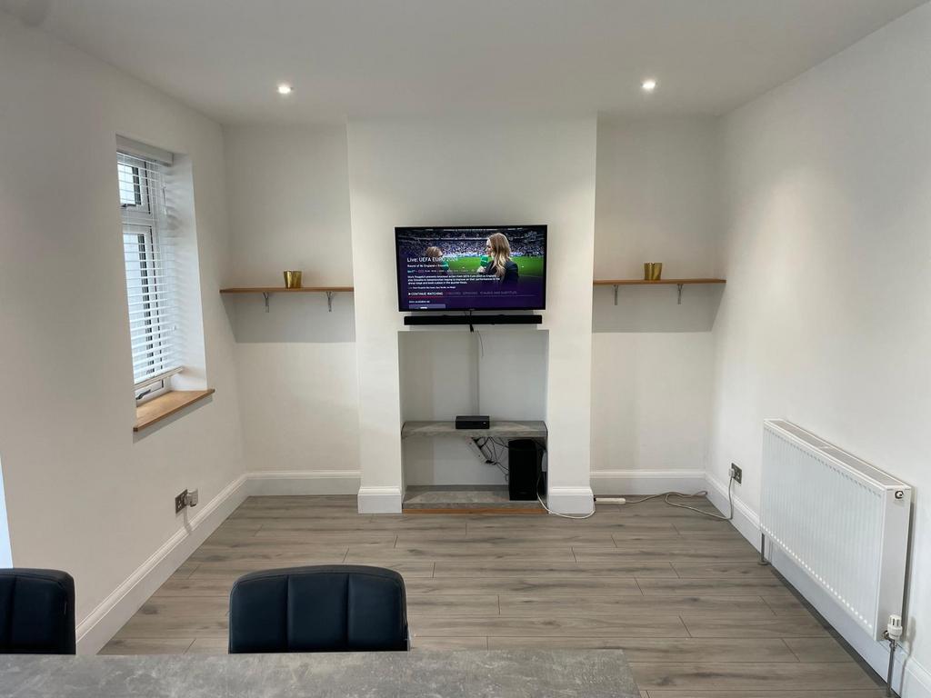 A modern, tidy living room featuring a mounted ...
