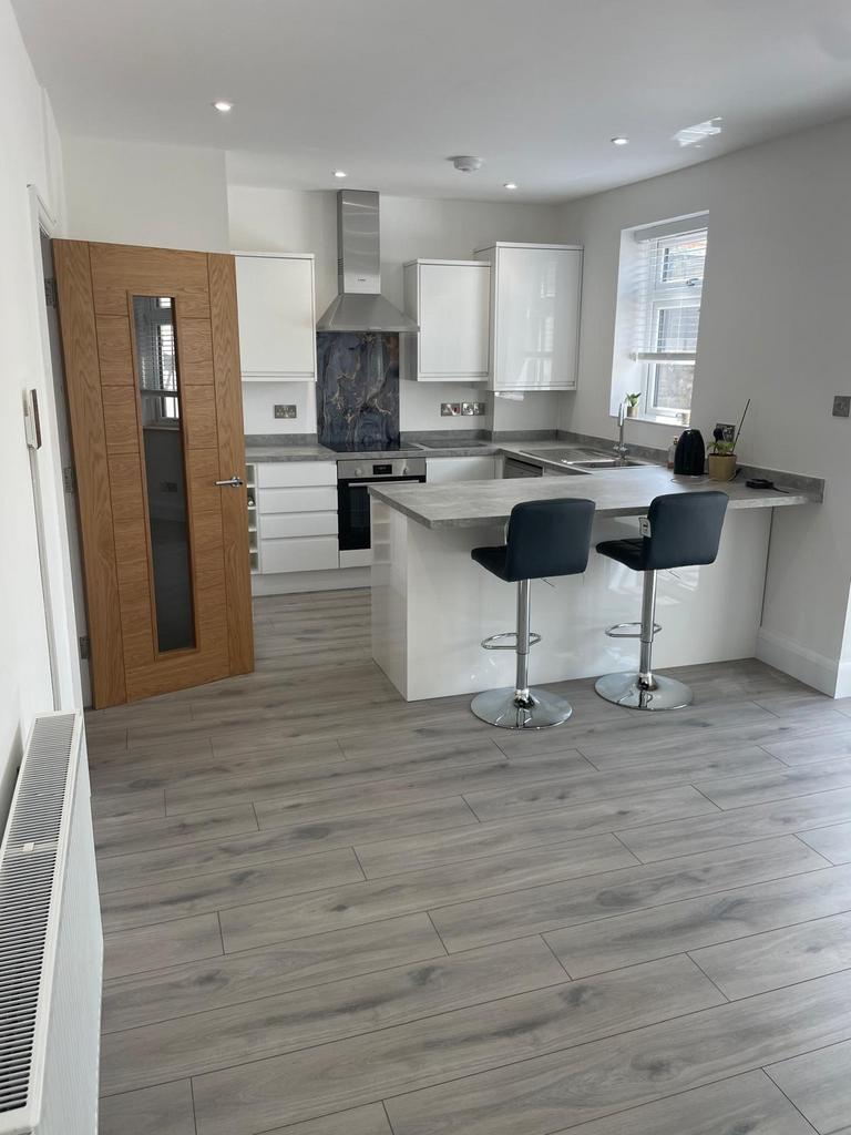 Bright and modern kitchen featuring sleek white...