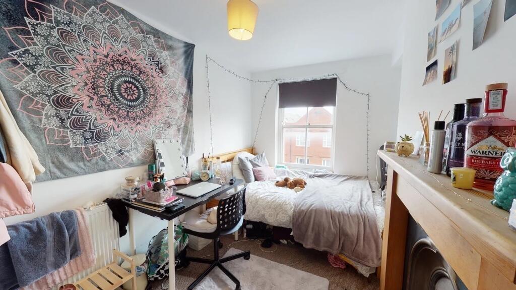 A cozy and well-kept bedroom featuring a comfor...