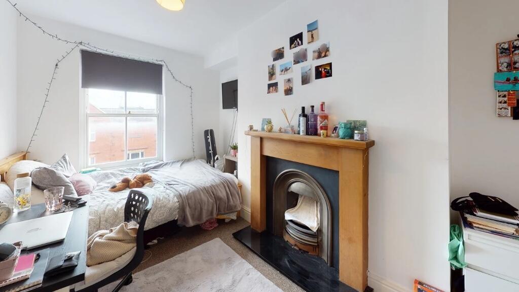 Bright and cozy master bedroom featuring a comf...