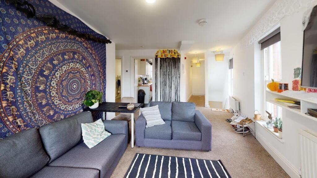 A cozy and inviting living room featuring comfo...