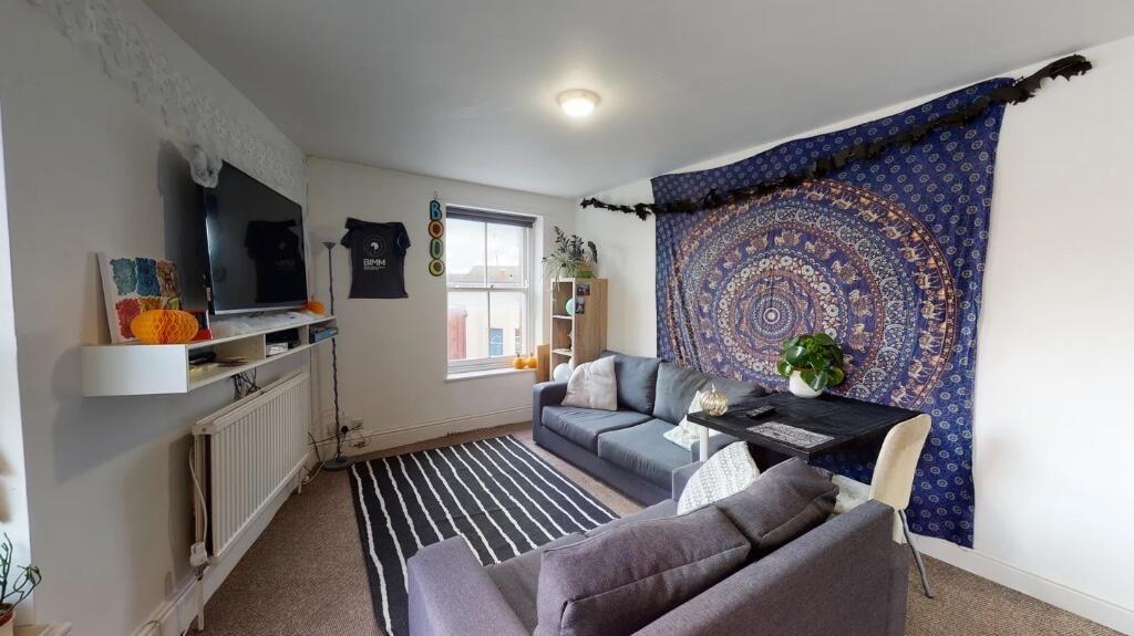 A bright and inviting living room featuring com...
