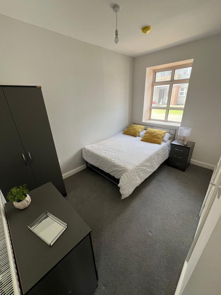 A cozy double bedroom featuring a comfortable b...