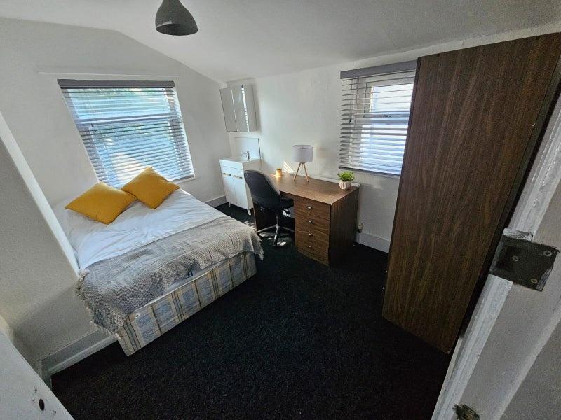 Bright and cozy double bedroom featuring a comf...