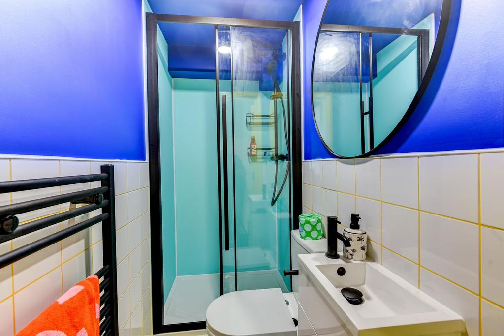 Modern bathroom featuring a sleek shower enclos...