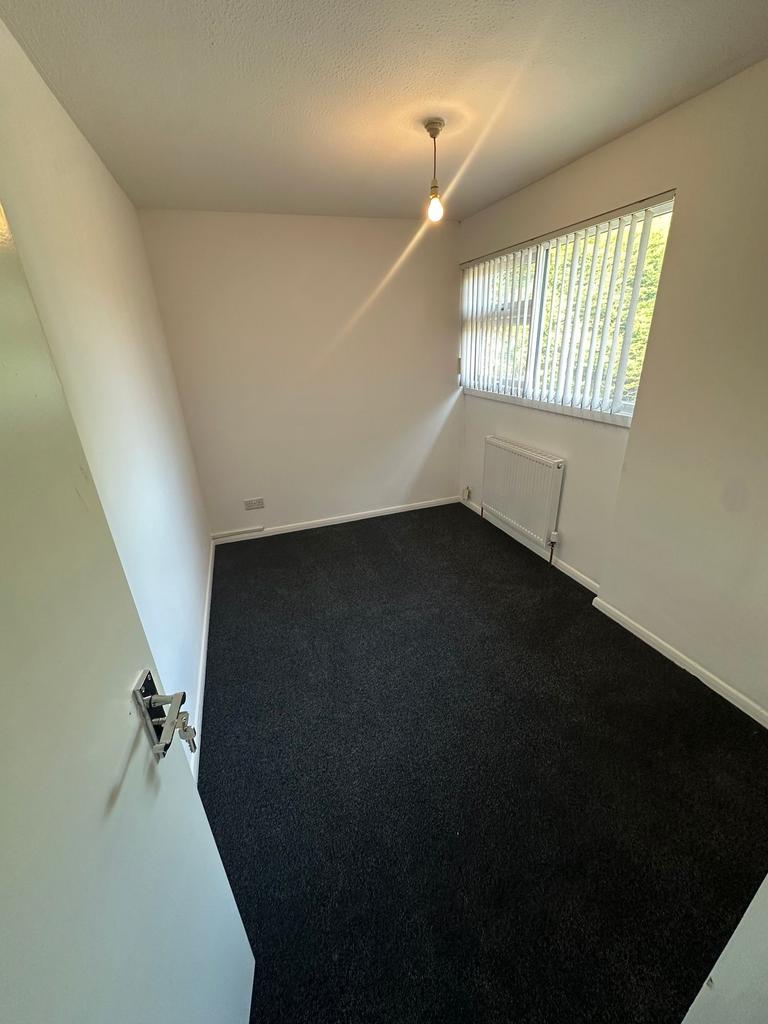 A neat and tidy single bedroom featuring dark c...