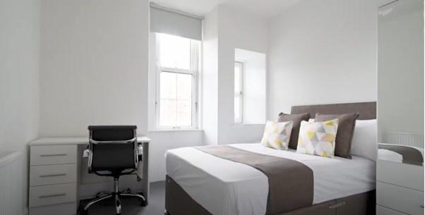 Bright and modern double bedroom featuring a co...
