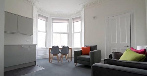 A bright and inviting living room featuring a l...