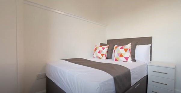 Bright and cozy double bedroom featuring a neat...
