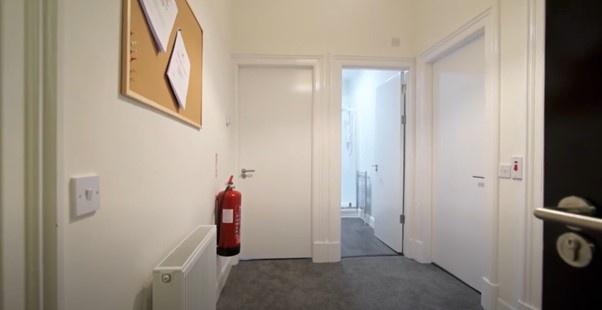 A clean, well-maintained hallway with neutral w...