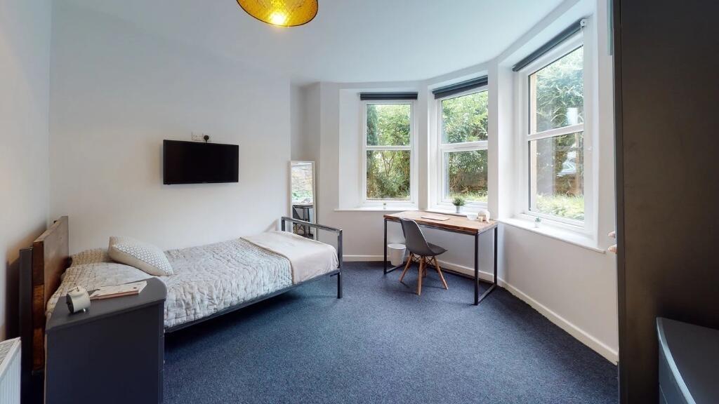 Bright and spacious master bedroom featuring a ...