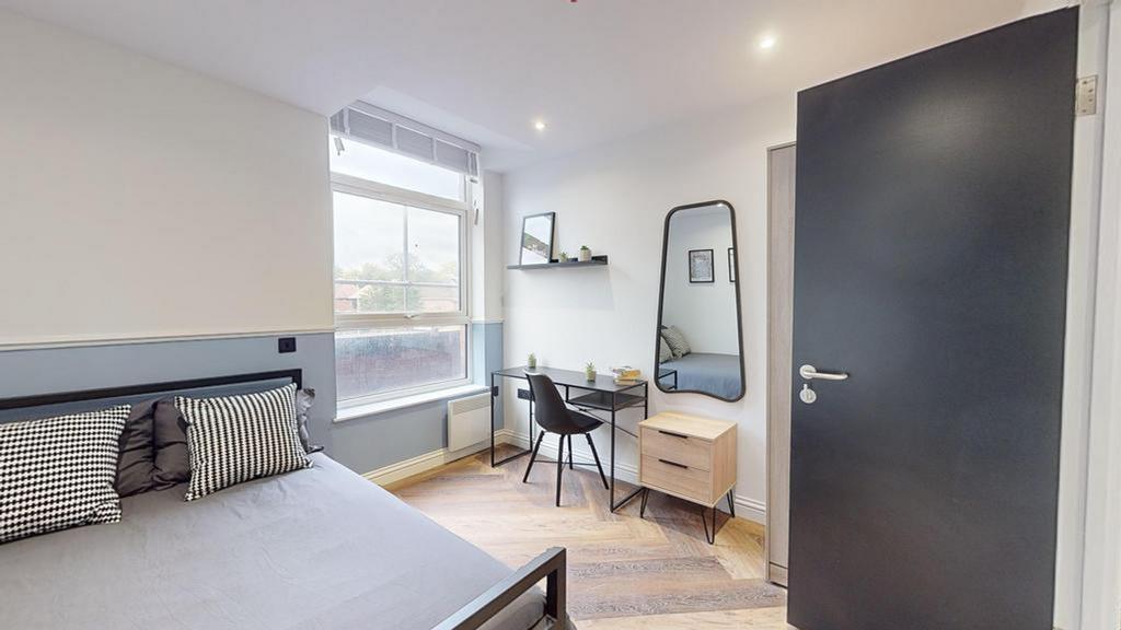 A bright and inviting double bedroom with moder...