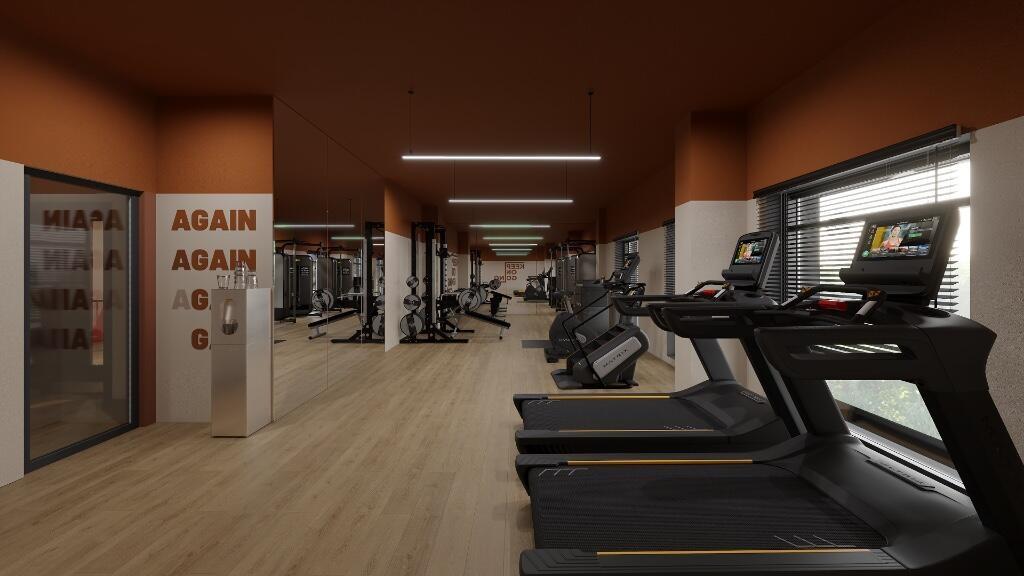 A modern gym space featuring multiple treadmill...