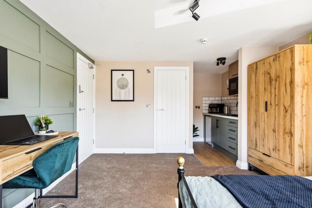 This charming double bedroom features a cozy la...