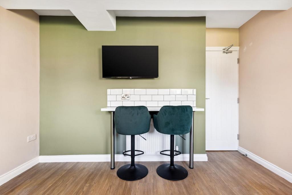 A modern communal workspace featuring a sleek b...
