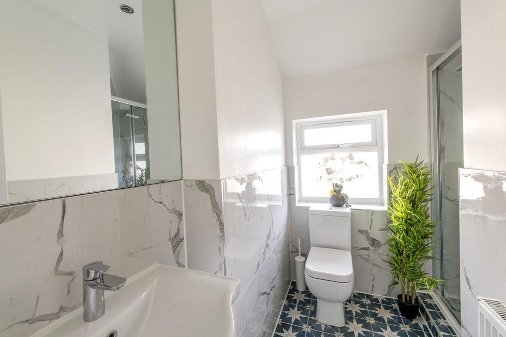 This stylish bathroom features modern fixtures,...