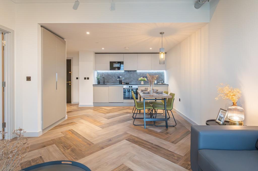 A modern and stylish kitchenette with ample nat...