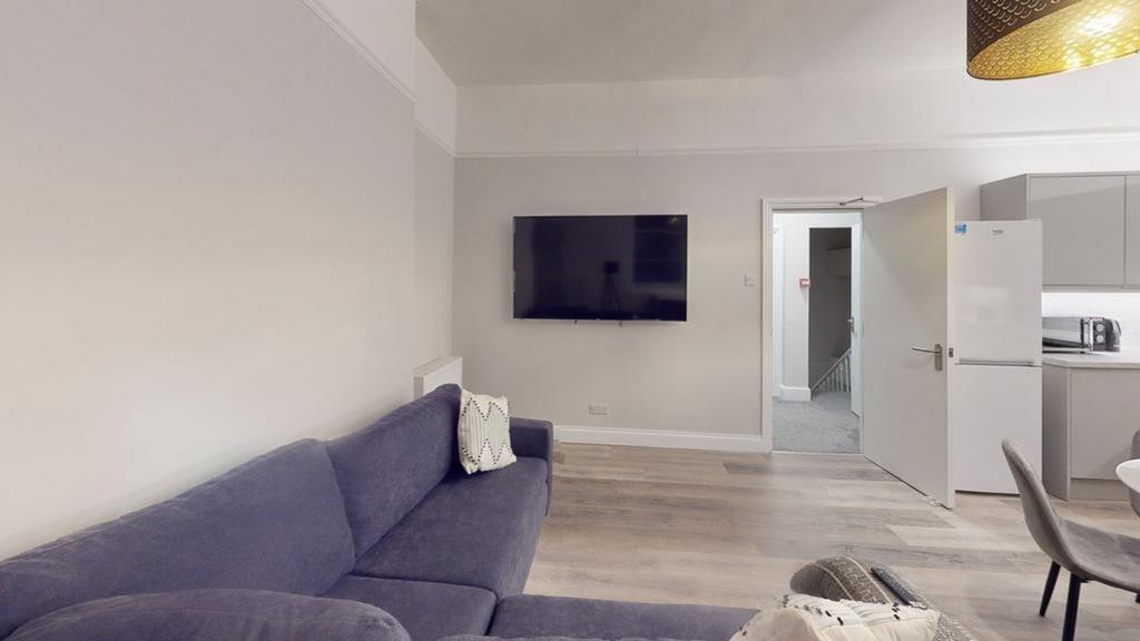 A spacious and inviting modern living room, per...