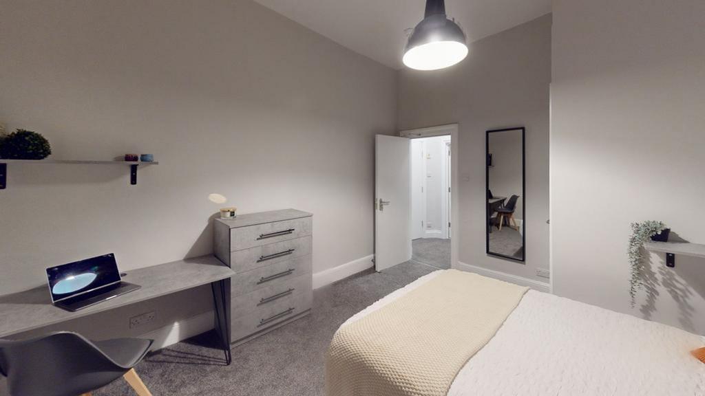 A stylish and spacious double bedroom featuring...