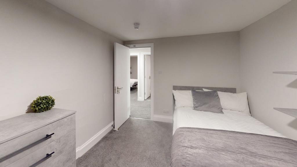 A spacious and tidy double bedroom with modern ...