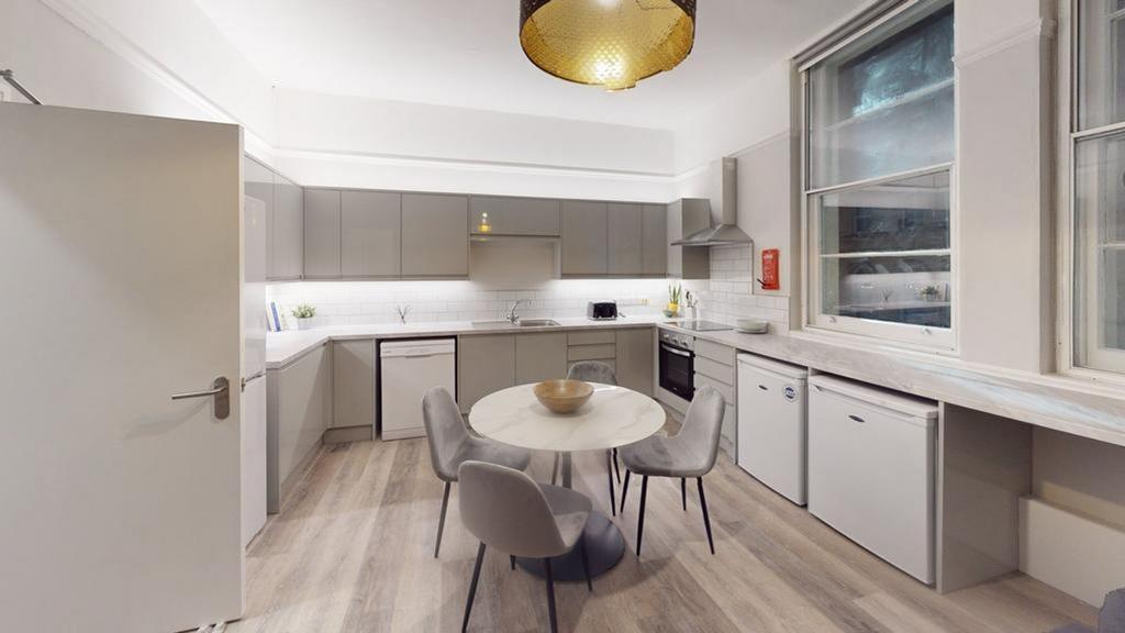 A modern and spacious kitchen with ample natura...