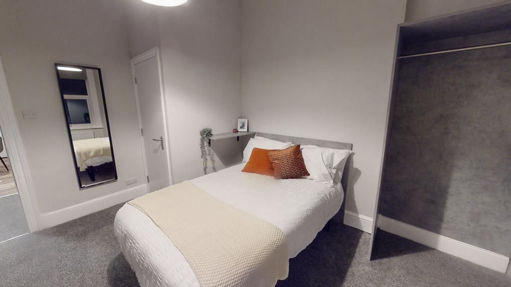 A bright and inviting double bedroom featuring ...