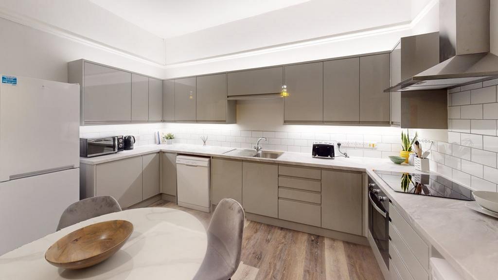 A modern and spacious kitchen with ample natura...