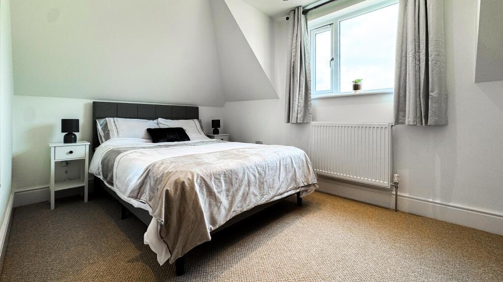 A cozy double bedroom featuring a comfortable b...