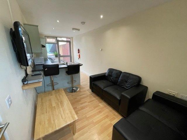 A neat and modern living room featuring a comfo...
