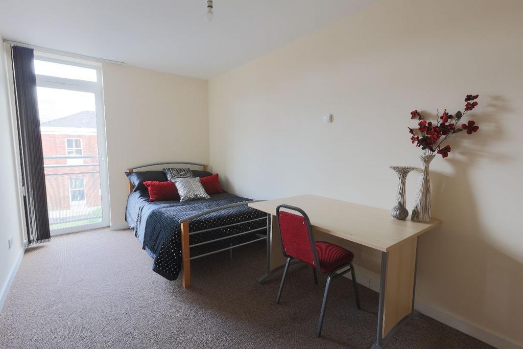 A bright and tidy bedroom featuring a single be...