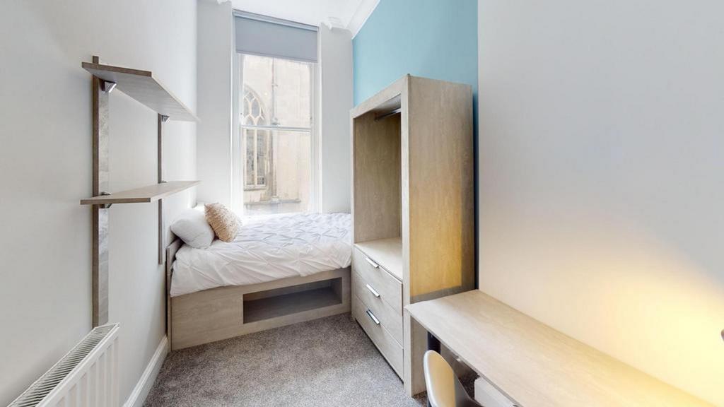 A bright and cozy double bedroom featuring styl...