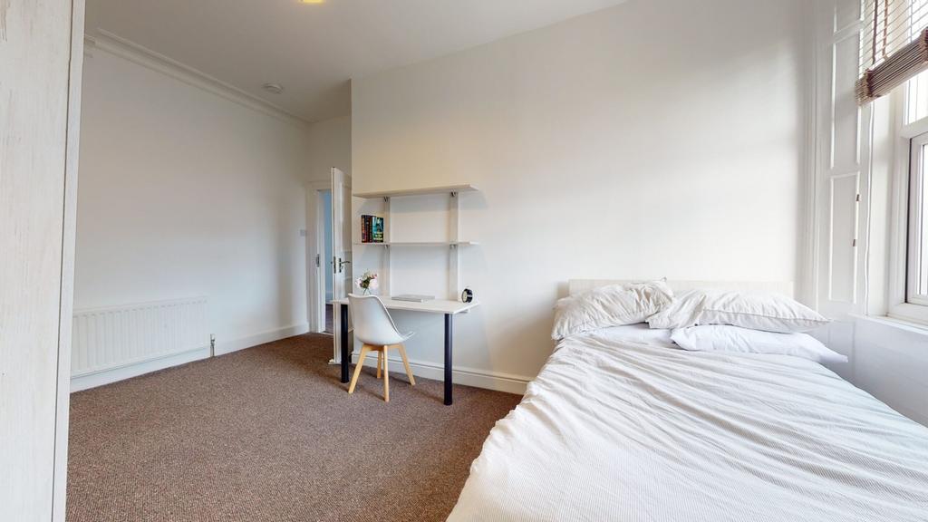 A bright and spacious double bedroom featuring ...