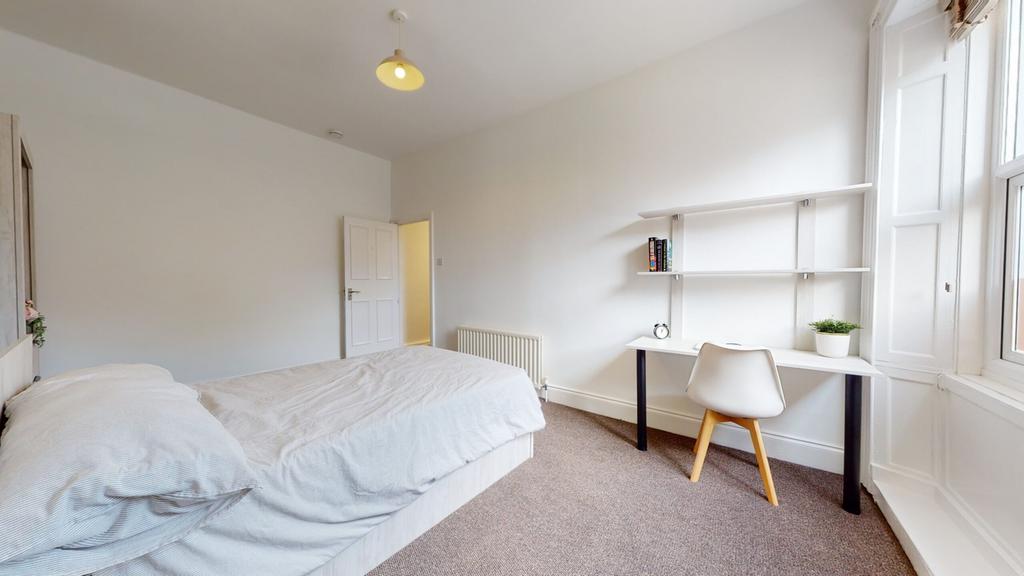 A bright and tidy double bedroom featuring a co...