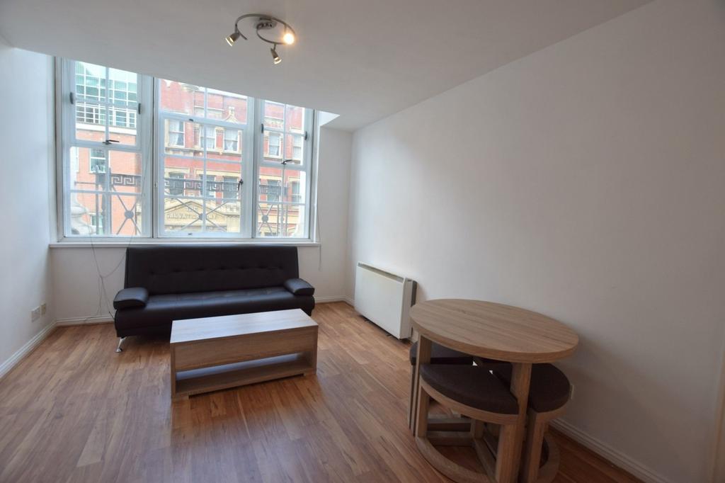 Bright and tidy living room featuring a large w...