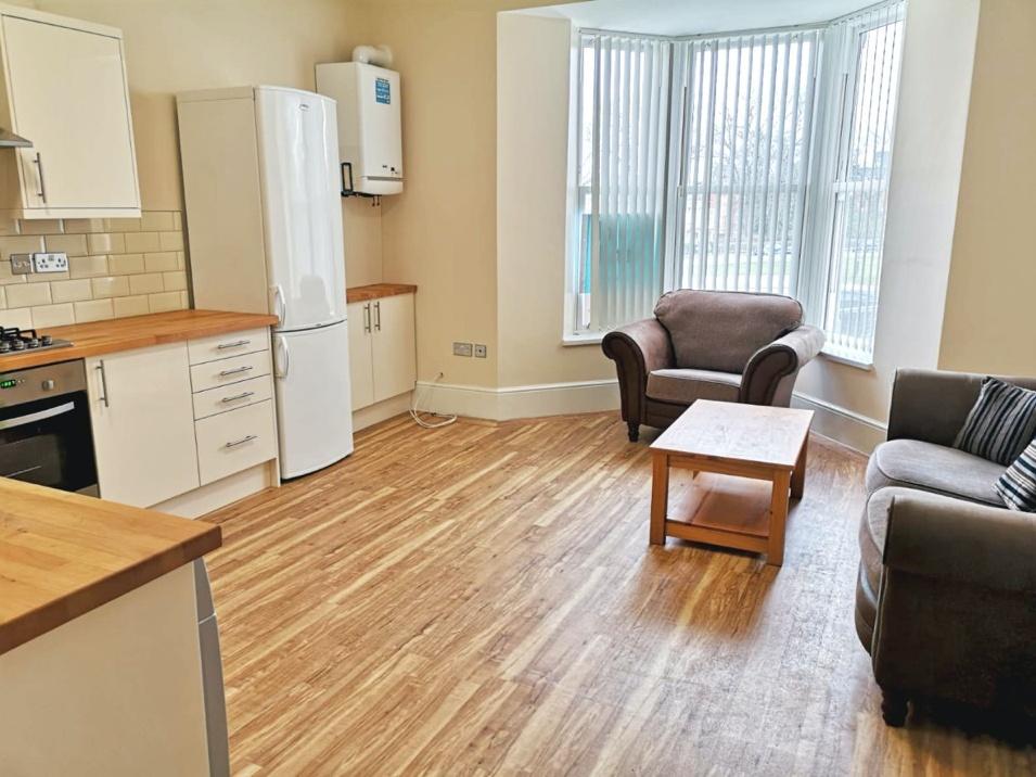 Spacious and bright living room featuring large...