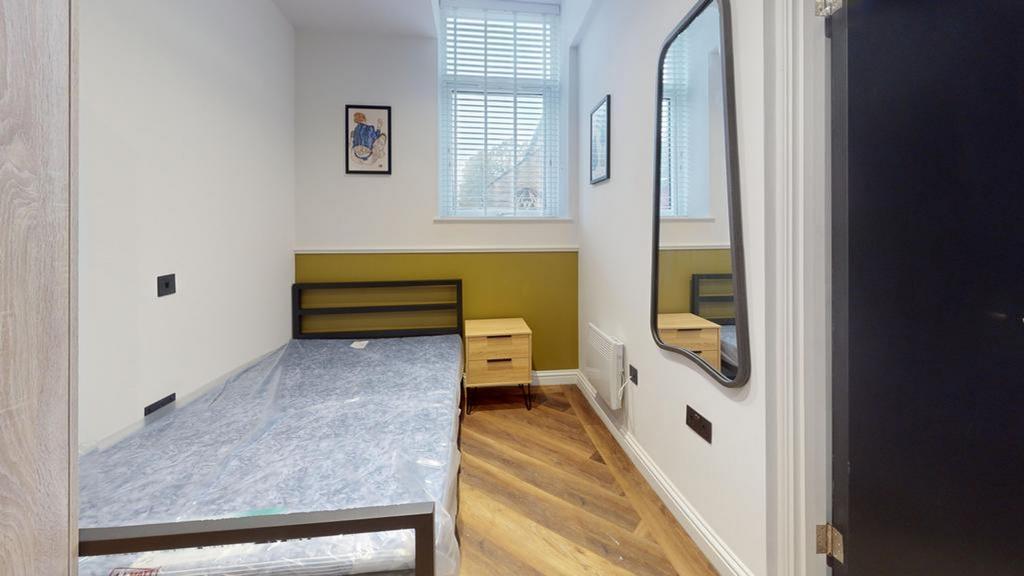 A bright and modern double bedroom with stylish...